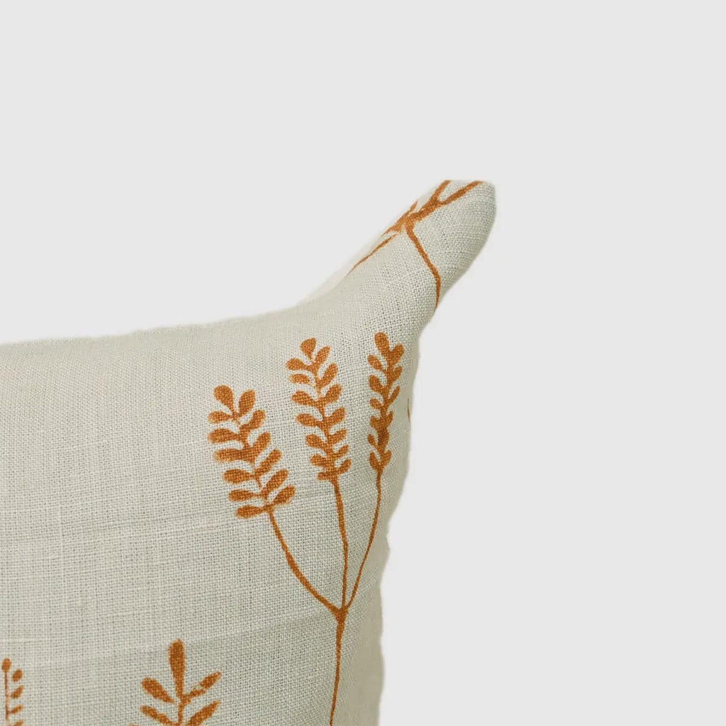 Close-up of rust botanical branch print on cream linen