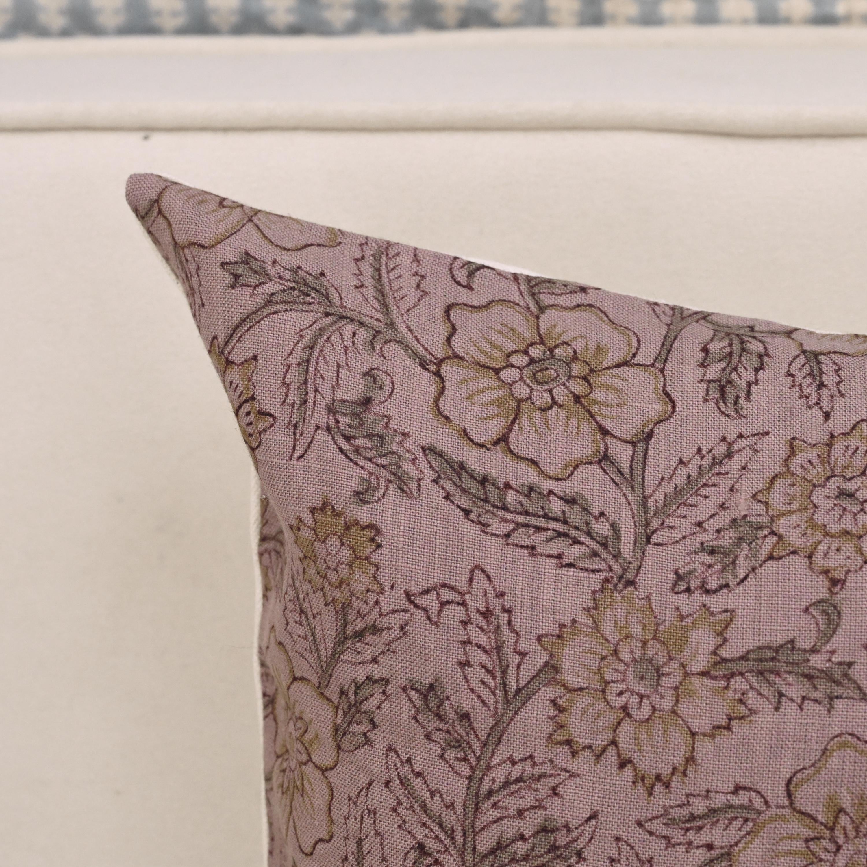 Mauve gold floral linen pillow cover styled on a sofa