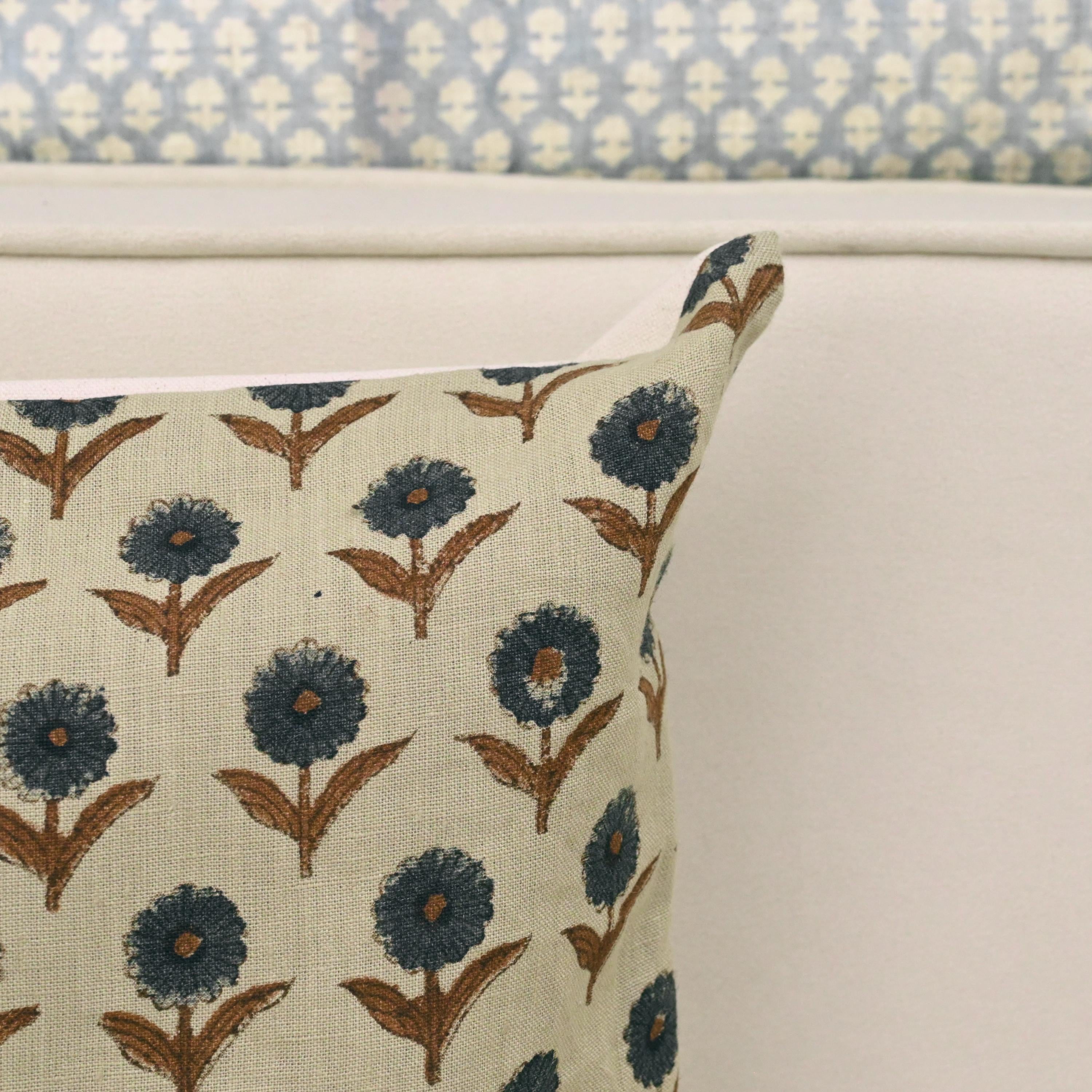 Navy floral linen pillow cover styled on a sofa