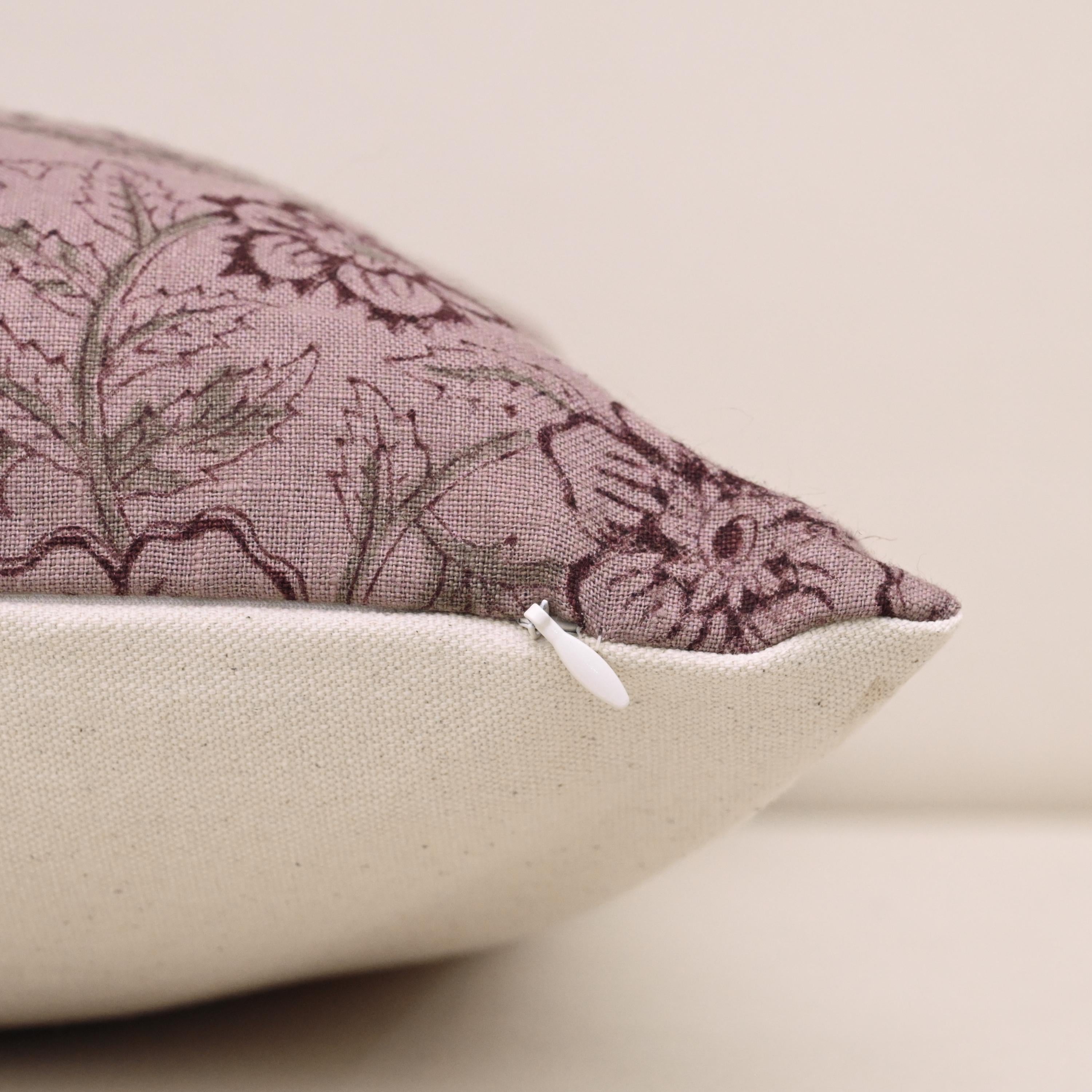 Close-up of plum floral block print outline on mauve linen pillow cover