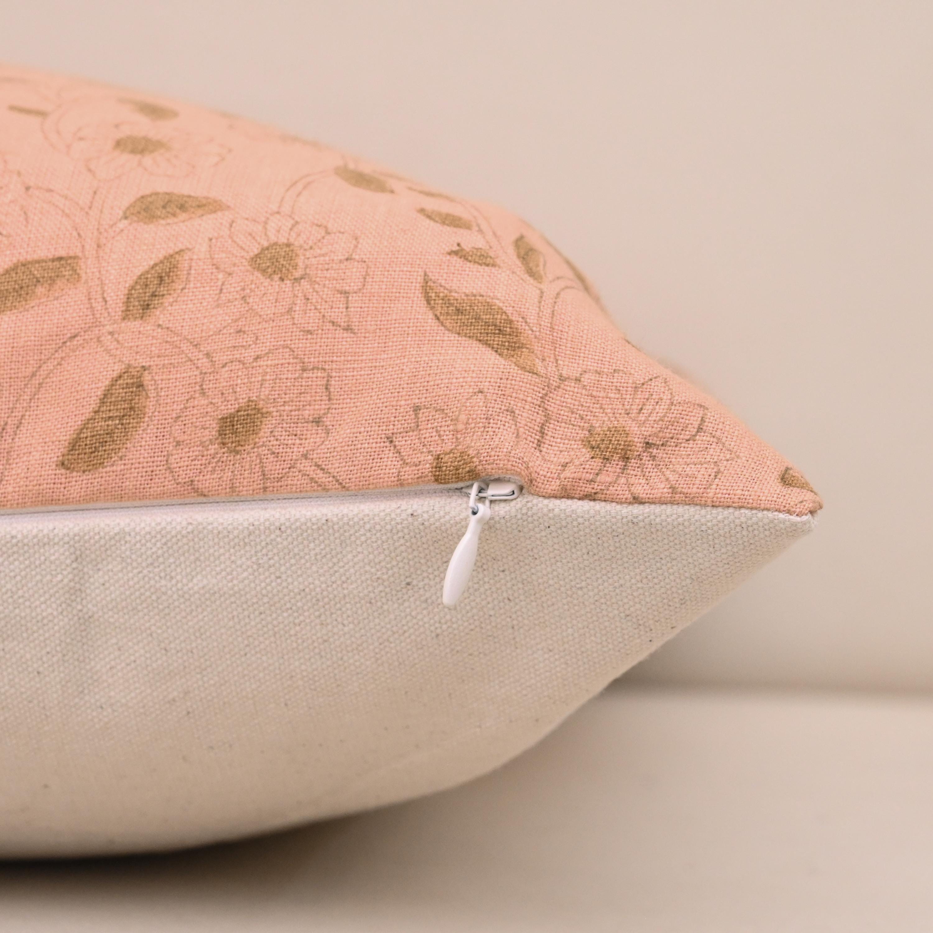 Hidden zipper and corner detail of blush pink linen pillow cover