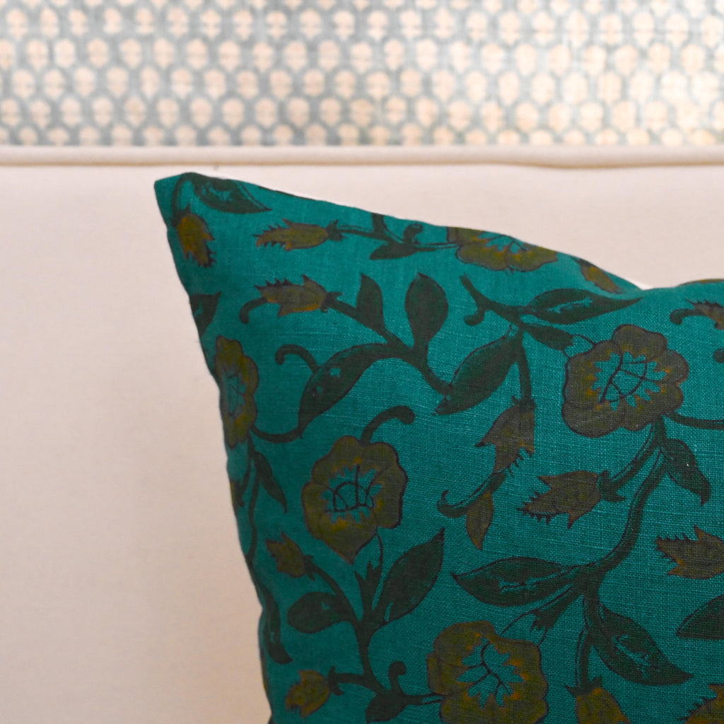 Close-up of teal wild rose vine block print with ochre gold accents