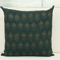 Forest green floral buti block print linen pillow cover styled on a sofa