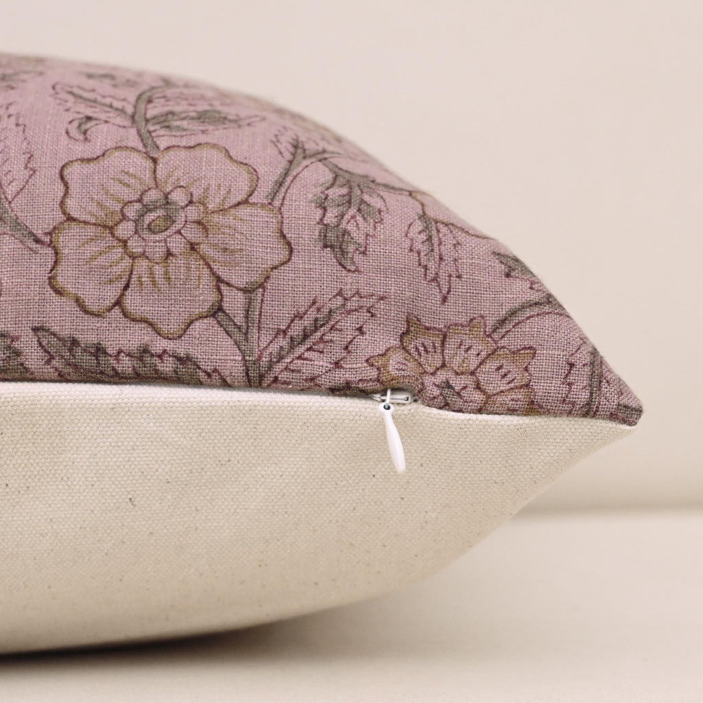 Close-up of gold floral block print detail on mauve linen pillow cover