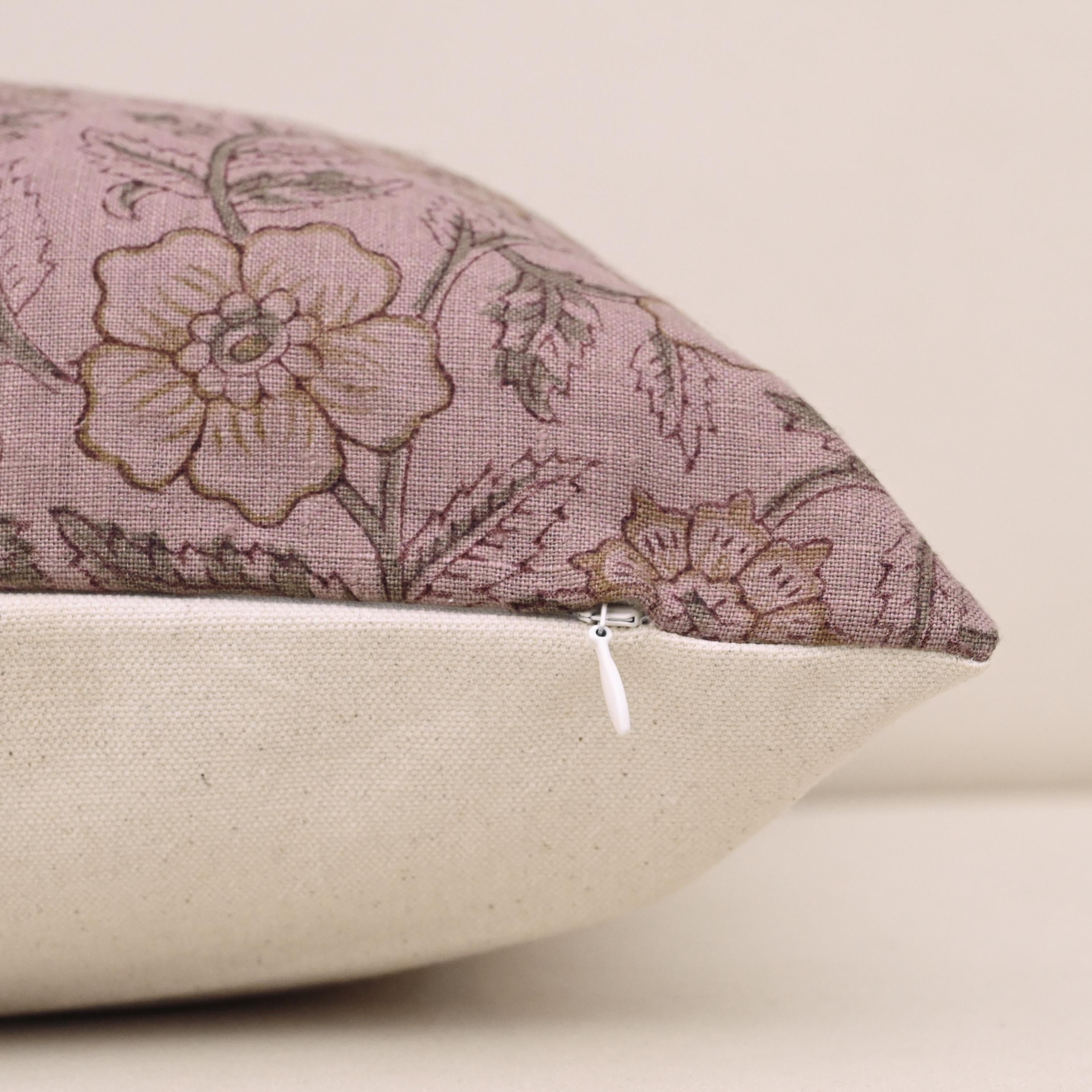 Close-up of gold floral block print detail on mauve linen pillow cover